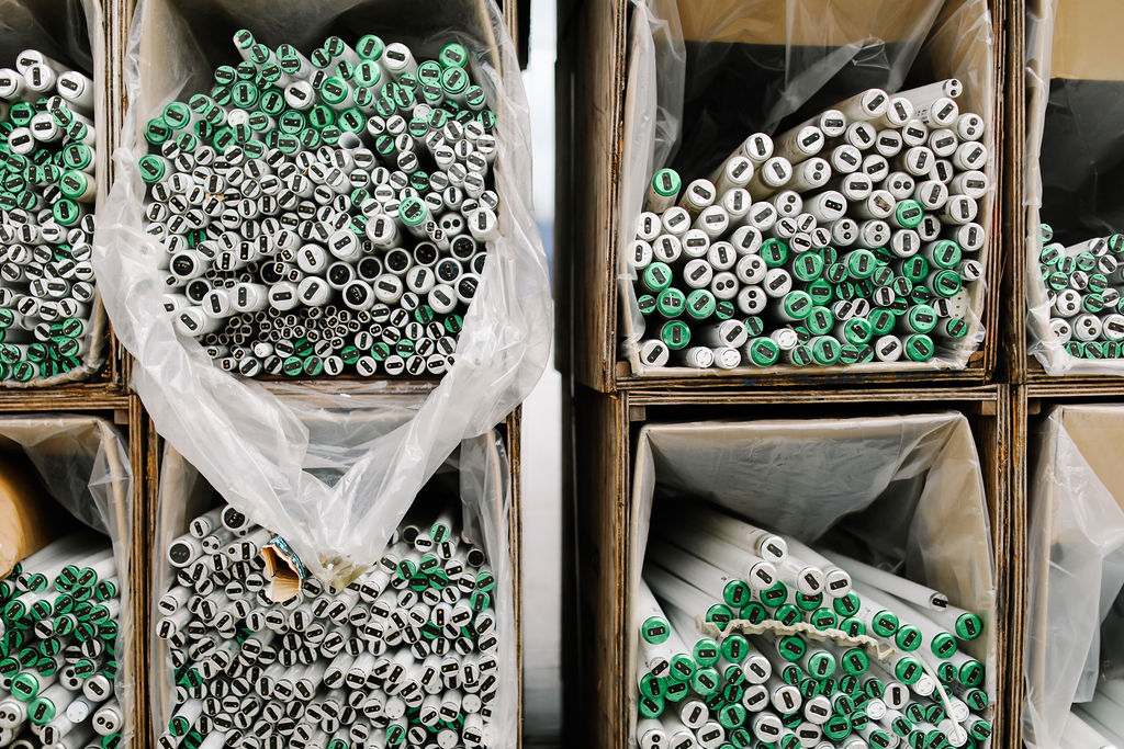 Fluorescent tubes sorted in recycling bulk bins.