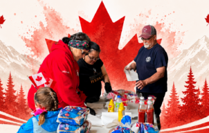 Canada Day - Volunteers gather around a table of food and supplies inside the Hopedale fire hall